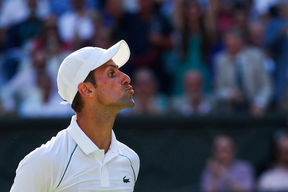 Serbia’s Novak Djokovic blows a kiss to somebody in the crowd as he plays against Britain’s Cameron Norrie during their men’s singles semi final tennis match on the twelfth day of the 2022 Wimbledon Championships at The All England Tennis Club in Wimbledon, southwest London, on July 8, 2022. AFPPIX