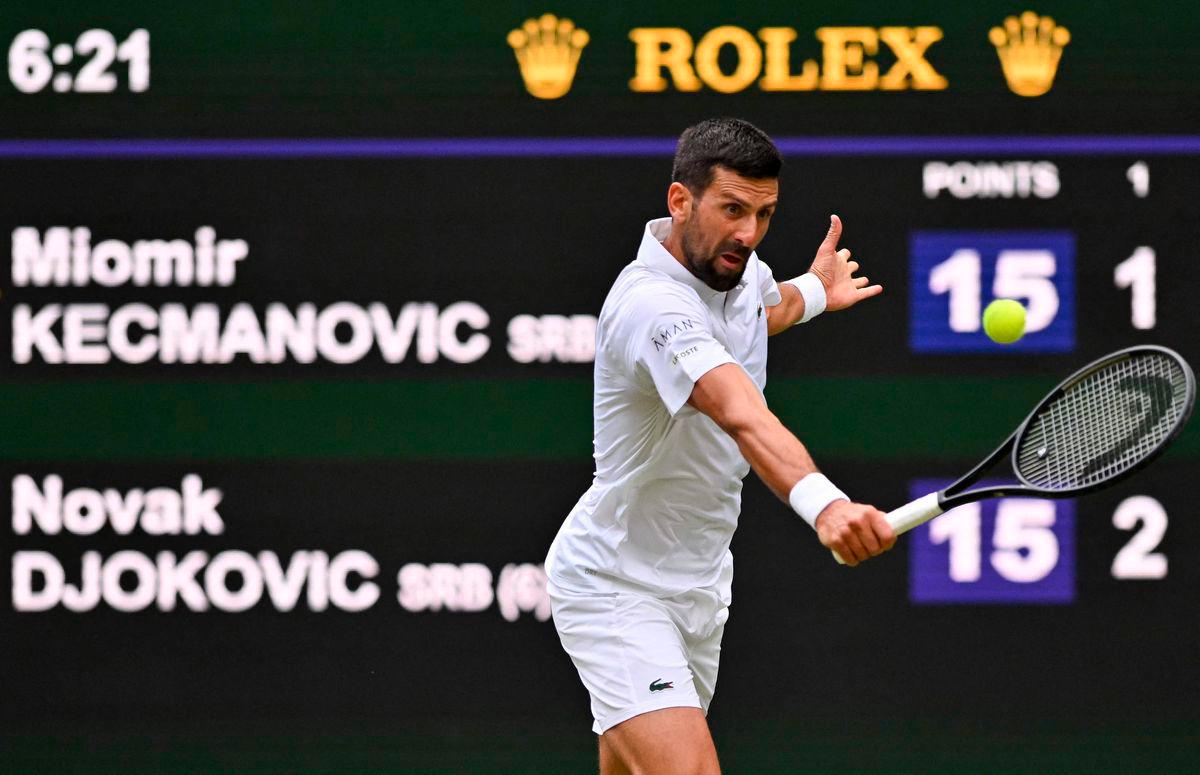 Serbia’s Novak Djokovic plays a backhand return to Serbia’s Miomir Kecmanovic during their men’s singles third round tennis match on the sixth day of the 2025 Wimbledon Championships at The All England Lawn Tennis and Croquet Club in Wimbledon, southwest London, on July 5, 2025 - Photo by Glyn KIRK / AFP