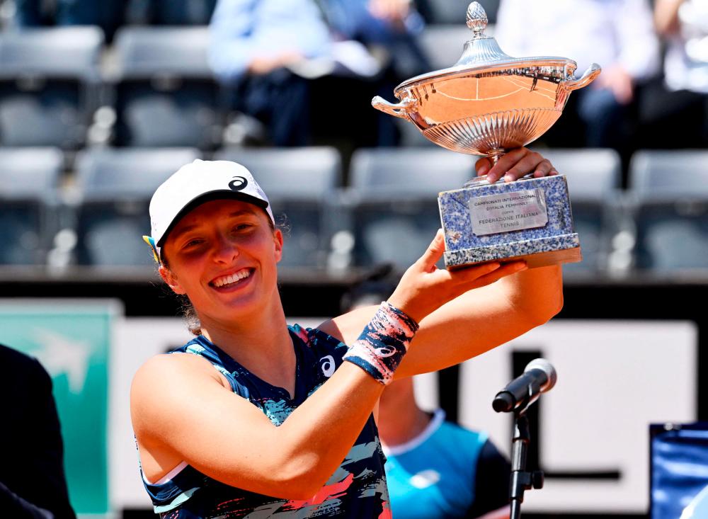 Poland’s Iga Swiatek poses with the winner’s trophy after defeating Tunisia’s Ons Jabeur to win the final of the Women’s WTA Rome Open tennis tournament on May 15, 2022 at Foro Italico in Rome. AFPPIX