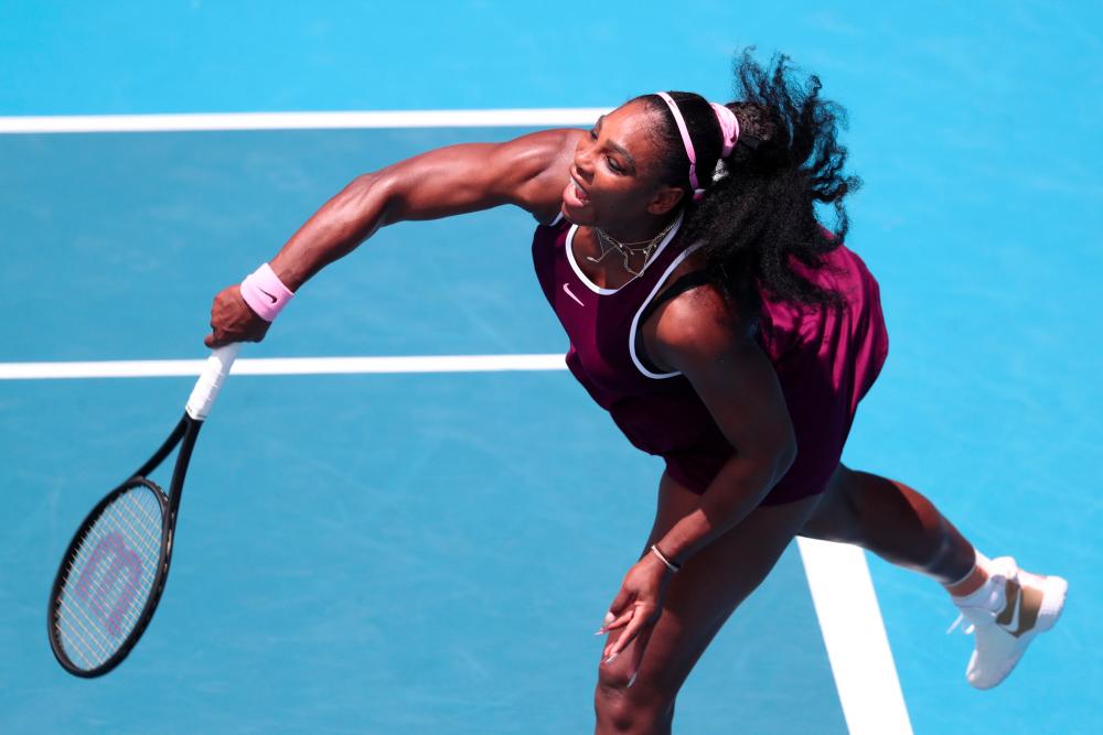 Serena Williams of the US serves against Laura Siegemund of Germany during their women's singles quarter-final match during the Auckland Classic tennis tournament in Auckland on Jan 10. — AFP
