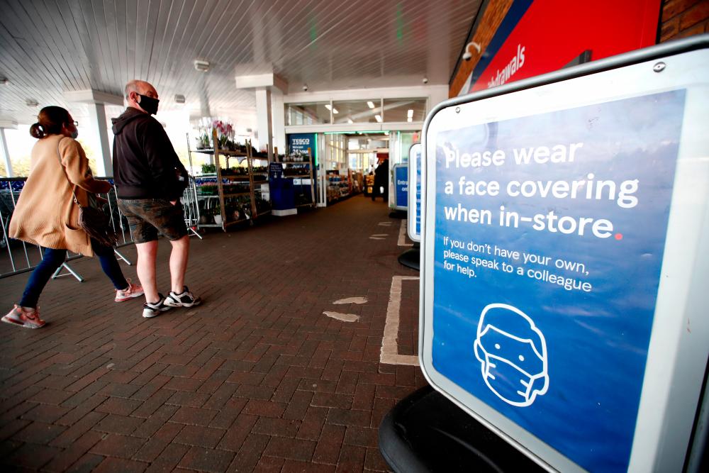 An information sign is seen at the entrance to a Tesco supermarket in Hatfield, Britain. – REUTERSPIX