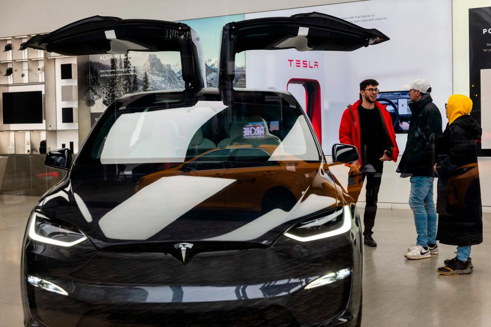 Tesla vehicles are displayed in a Manhattan showroom on Wednesday in New York City. An analyst says Tesla is increasingly looking like a traditional auto company. – AFPpic