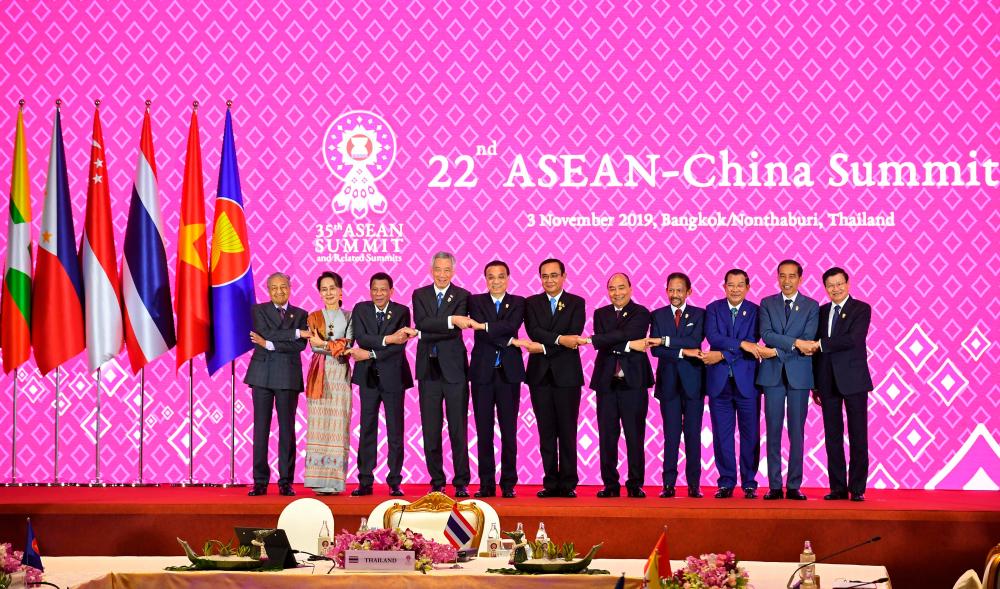 (From L to R) Prime Minister Tun Dr Mahathir Mohamad, Myanmar's State Counsellor Aung San Suu Kyi, Philippines' President Rodrigo Duterte Singapore's Prime Minister Lee Hsien Loong, China's Premier Li Keqiang, Thailand's Prime Minister Prayut Chan-O-Cha Vietnam's Prime Minister Nguyen Xuan Phuc, Brunei's Sultan Hassanal Bolkiah, Cambodia's Prime Minister Hun Sen, Indonesia's President Joko Widodo and Laos' Prime Minister Thongloun Sisoulith pose for a group photo during the 22nd ASEAN-China Summit in Bangkok on Nov 3, 2019, on the sidelines of the 35th Association of Southeast Asian Nations (Asean) Summit. — AFP