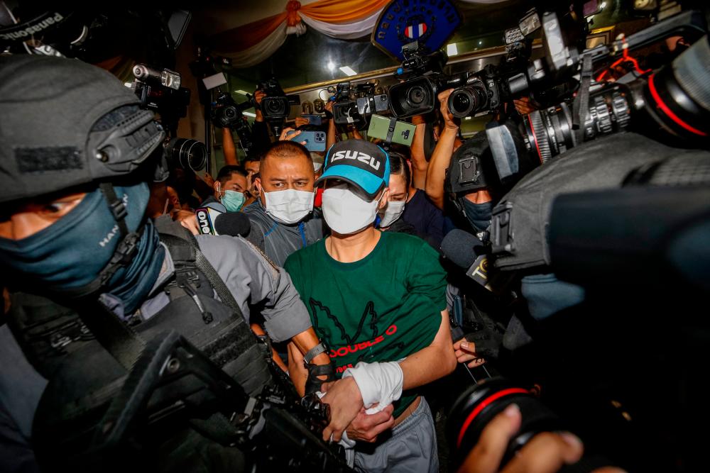 This picture taken on August 26, 2021 shows former Nakhon Sawan province district police station chief Thitisan Utthanaphon, nicknamed “Joe Ferrari”, leaving the Crime Suppression Division in Bangkok, after he surrendered to the authorities following accusations of torture and suffocation to death of a drug suspect. AFPpix