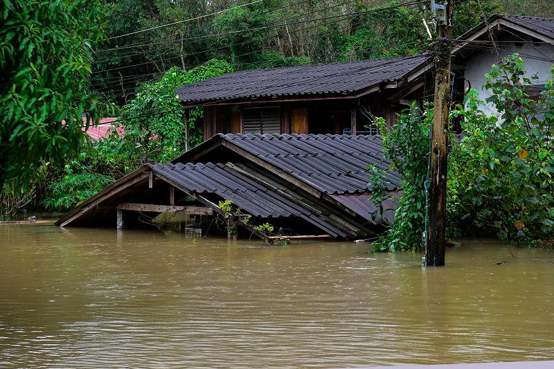 A house is seen submerged in floodwaters following heavy rain in Thailand’s southern province of Narathiwat on December 25, 2023. Floods caused by intense rainfall have affected tens of thousands of people in Thailand’s deep south, officials said December 25, with some roads and railway lines forced to close. - Madaree TOHLALA / AFP