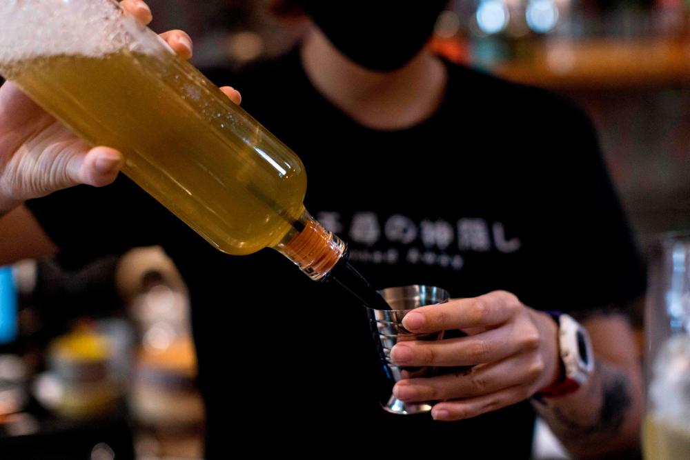 This picture taken on October 9, 2021 shows a member of the bar staff preparing a kratom-infused mocktail at the Teens of Thailand cocktail bar in Bangkok. AFPpix