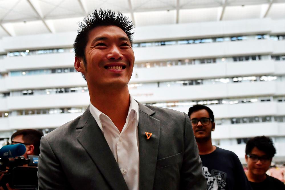 Thanathorn Juangroongruangkit, billionaire leader of opposition Future Forward Party, arrives to face his first hearing over disputed media shares at the Constitutional Court in Bangkok on Oct 18, 2019. — AFP