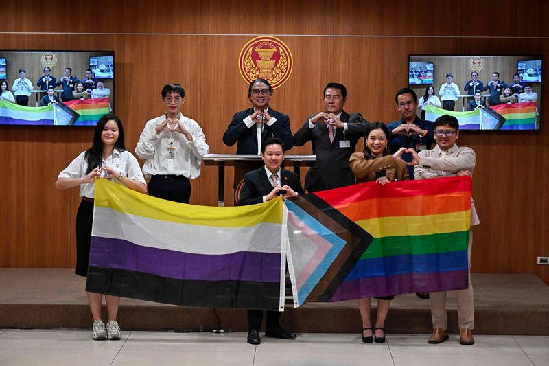 Members of Parliament (MPs) and parliamentary interns from the Move Forward Party (MFP) pose during a presser ahead of the final senatorial vote on the same sex marriage bill at the Thai Parliament in Bangkok on June 18, 2024. - AFPPIX