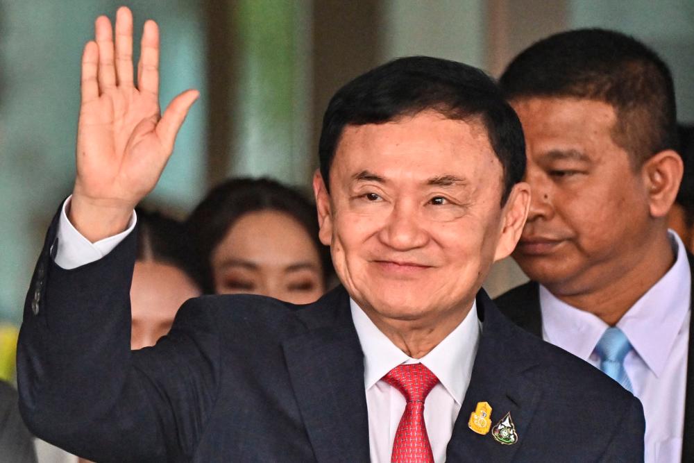 Former Thai Prime Minister Thaksin Shinawatra greets his supporters after landing at Bangkok’s Don Mueang airport on August 22, 2023/AFPPix