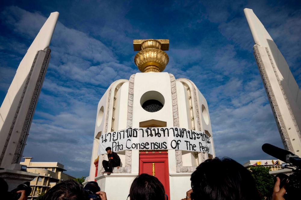 A banner is wrapped around the Democracy Monument during a protest following the suspension of Move Forward Party leader and prime ministerial candidate Pita Limjaroenrat in Bangkok on July 19, 2023/AFPPix