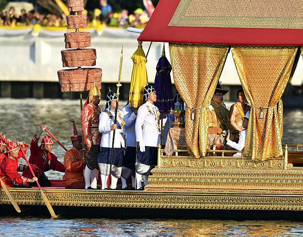 Thailand’s King Maha Vajiralongkorn, his wife Queen Suthida and Prince Dipangkorn Rasmijoti sit at the Royal barge during the Royal Barge procession, in Bangkok on Dec 12, 2019 — AFP