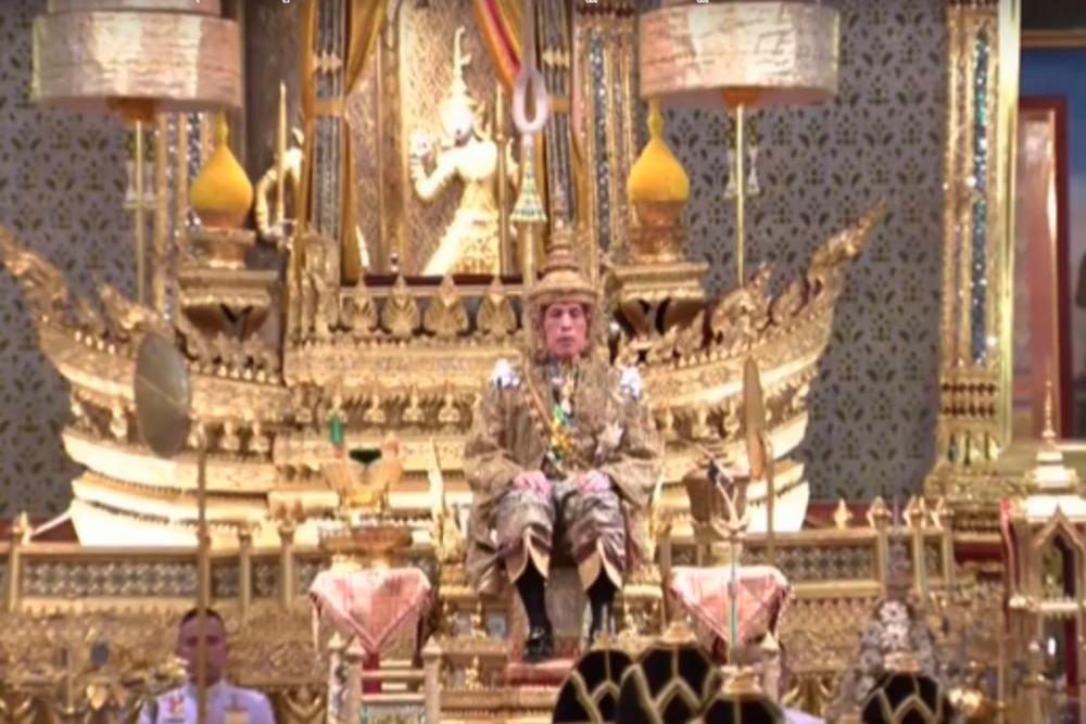 This framegrab handout from the Thai Royal Household Bureau taken and released on May 4, 2019 shows Thailand's King Maha Vajiralongkorn faces the audience wearing the gold crown while sitting on the throne during his coronation in Bangkok. - AFP