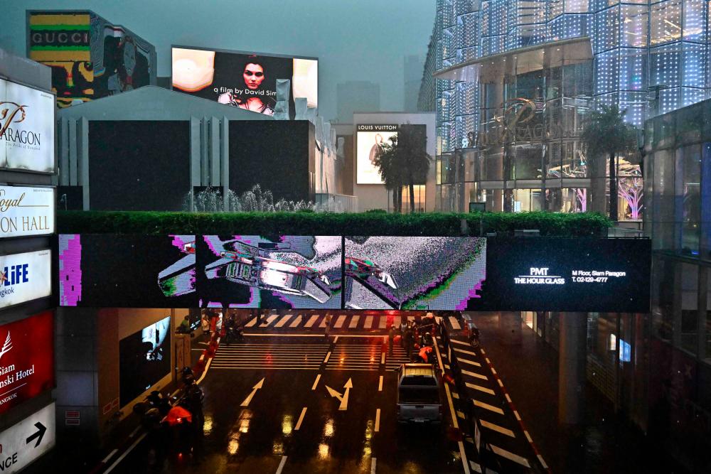 Thai police officers stand at an entrance at Siam Paragon mall in downtown Bangkok on October 3, 2023/AFPPix