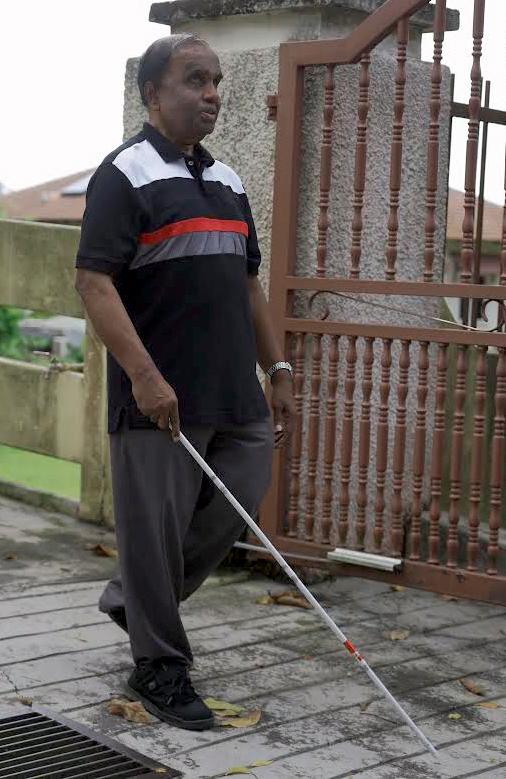 Thavasothy using a white cane to get around. Amirul Syafiq/THESUNpix