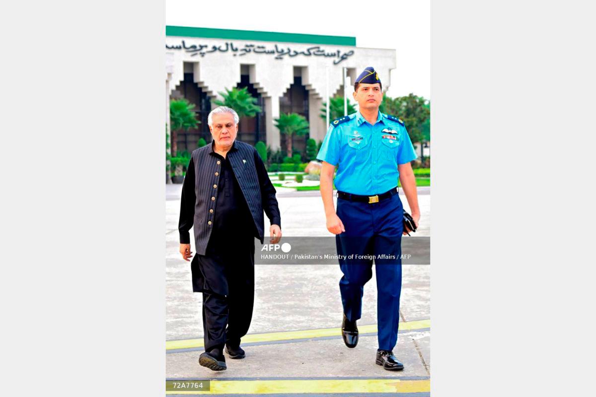 In this handout photograph taken and released by Pakistan’s Ministry of Foreign Affairs on August 23, 2025, Pakistan’s Foreign Minister Ishaq Dar (L) departs for Bangladesh, from Islamabad. Pakistan’s foreign minister flew to Bangladesh on August 23 as the nations, once bitter enemies after they split in 1971, seek to rebuild ties with regional power balances shifting. - HANDOUT / Pakistan’s Ministry of Foreign Affairs / AFP