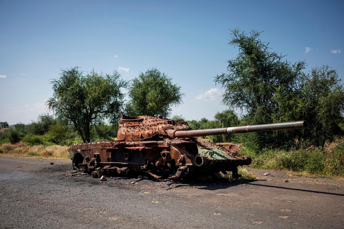 The charred remaining of a T-72 tank lay on the road that connects Shiraro to Shire on October 12, 2024. The two-year war in Ethiopia's Tigray region left hundreds of thousands people dead, more than one million still displaced and cost more than $20 billion in damage, until a peace deal in November 2022 ended the bloodshed.The war erupted in November 2020 when Prime Minister Abiy Ahmed sent the army to overthrow the leaders of the northern Tigray region, accusing their forces of attacking federal military bases. - Michele Spatari / AFP