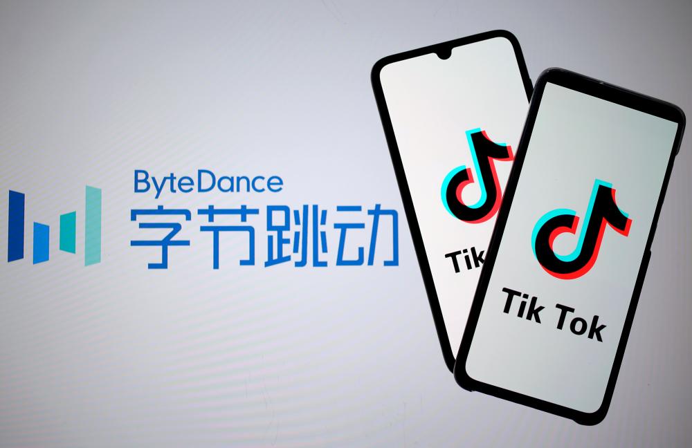 Tik Tok logos are seen on smartphones in front of a displayed ByteDance logo in this illustration. – REUTERSPIX