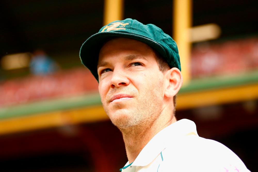 In this file photo taken on January 3, 2020, Australia's wicketkeeper and captain Tim Paine looks on during the first day of the third cricket Test match between Australia and New Zealand at the Sydney Cricket Ground in Sydney. Tim Paine announced his shock resignation as Australian Test cricket captain on November 19, 2021 over what he described as an inappropriate private text exchange with a then-colleague. -AFPPix