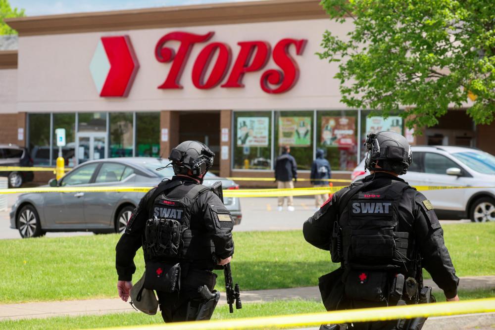 Members of the Buffalo Police department work at the scene of a shooting at a Tops supermarket in Buffalo, New York, U.S. May 17, 2022. REUTERSpix