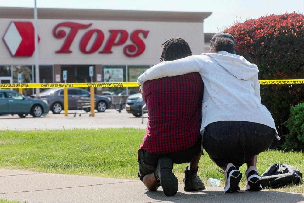 Mourners react while attending a vigil for victims of the shooting at a TOPS supermarket in Buffalo, New York, U.S. May 15, 2022. REUTERSpix