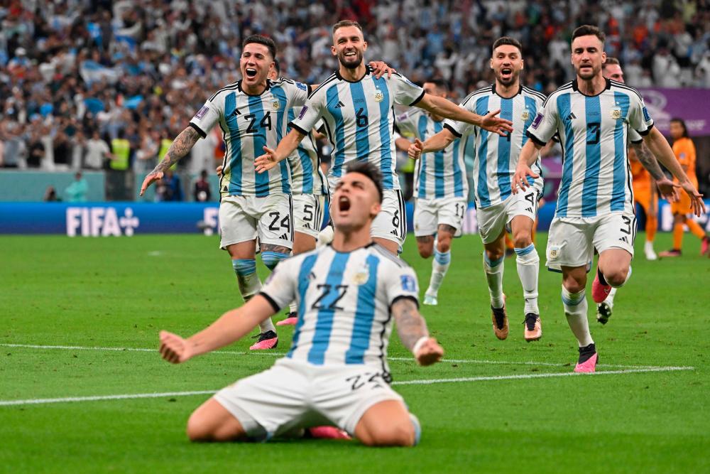 Argentina's forward #22 Lautaro Martinez celebrates after scoring his penalty and qualifying to the next round after defeating Netherlands in the penalty shoot-out of the Qatar 2022 World Cup quarter-final football match between Netherlands and Argentina at Lusail Stadium, north of Doha, on December 9, 2022/AFPix