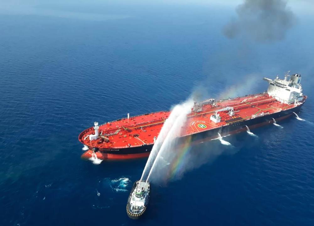 A picture obtained by AFP from Iranian news agency Tasnim on June 13, 2019 reportedly shows an Iranian navy boat trying to control fire from Norwegian owned Front Altair tanker said to have been attacked in the waters of the Gulf of Oman. - AFP