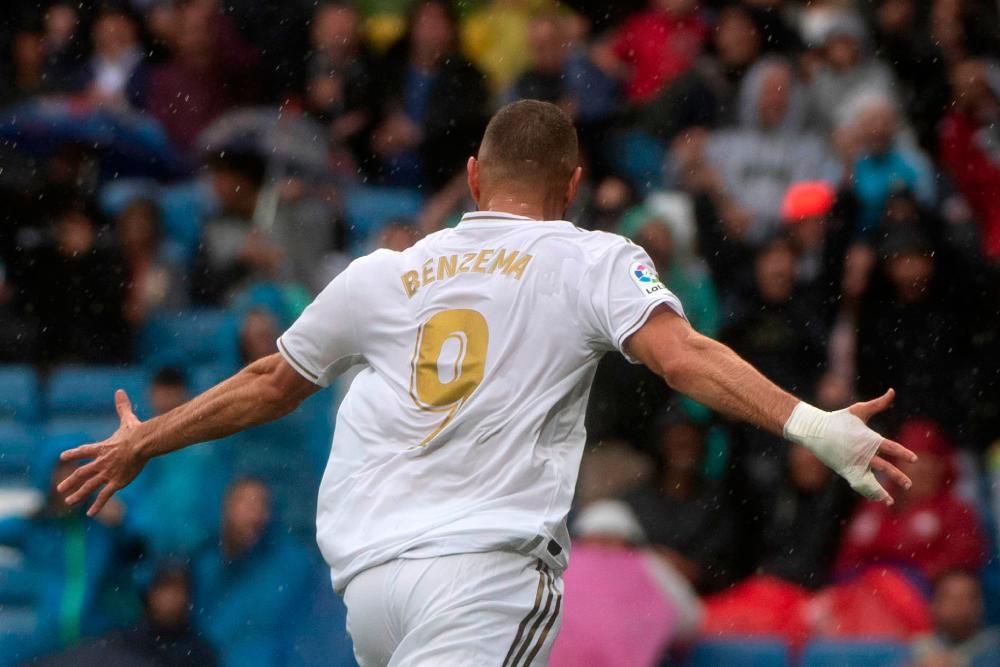Real Madrid's French forward Karim Benzema celebrates after scoring during the Spanish league football match Real Madrid CF against Levante UD at the Santiago Bernabeu stadium in Madrid on Sept 14, 2019. - AFP