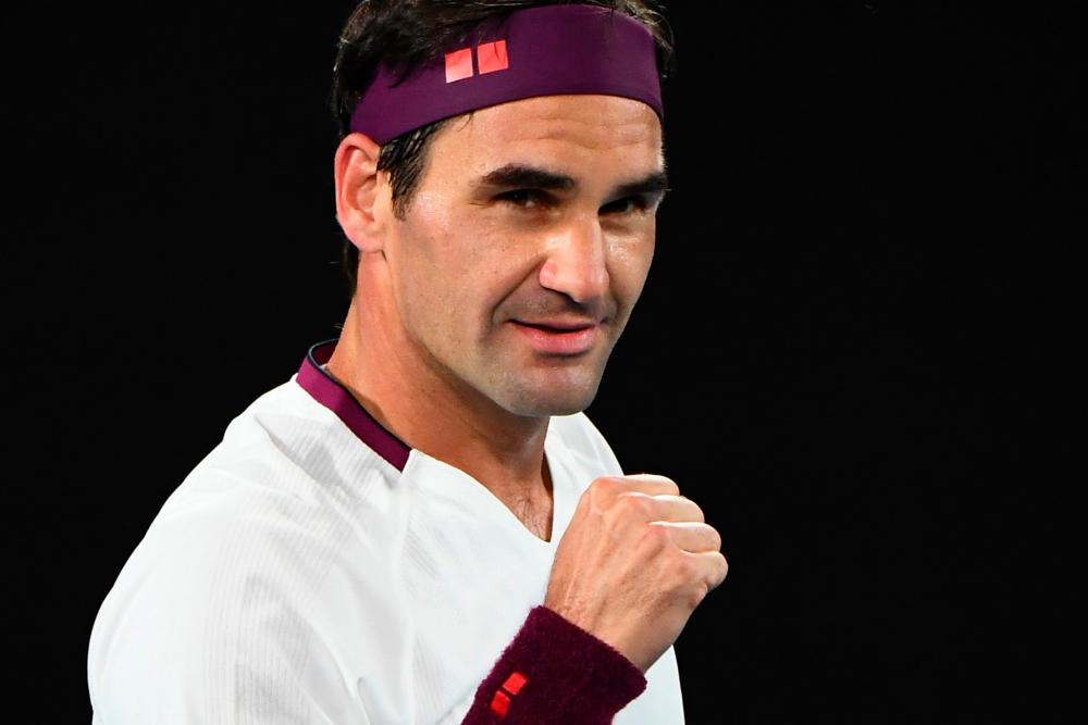 Switzerland's Roger Federer celebrates after victory against Hungary's Marton Fucsovics during their men's singles match on day seven of the Australian Open tennis tournament in Melbourne on January 26, 2020. - AFP