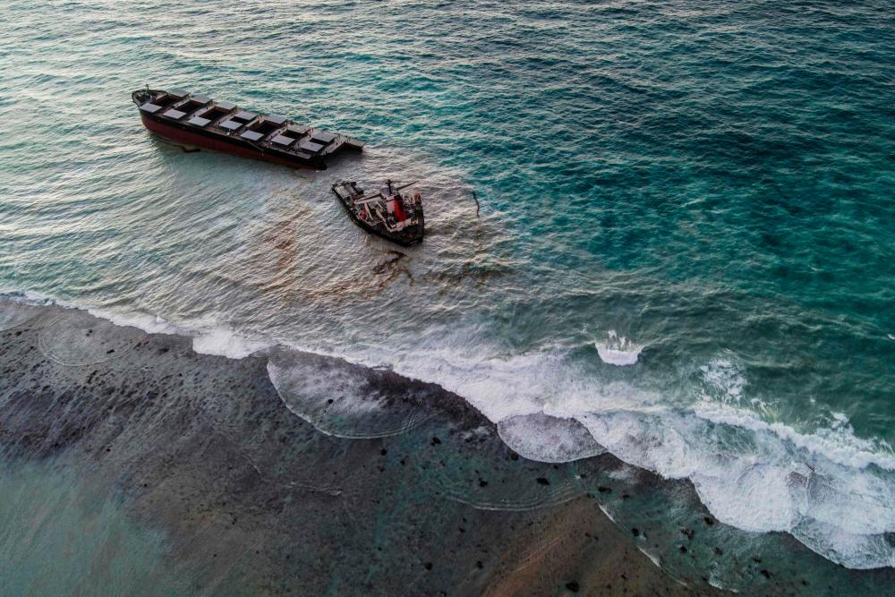 This aerial picture taken on August 16, 2020, shows the MV Wakashio bulk carrier that had run aground and broke into two parts near Blue Bay Marine Park, Mauritius. - AFP