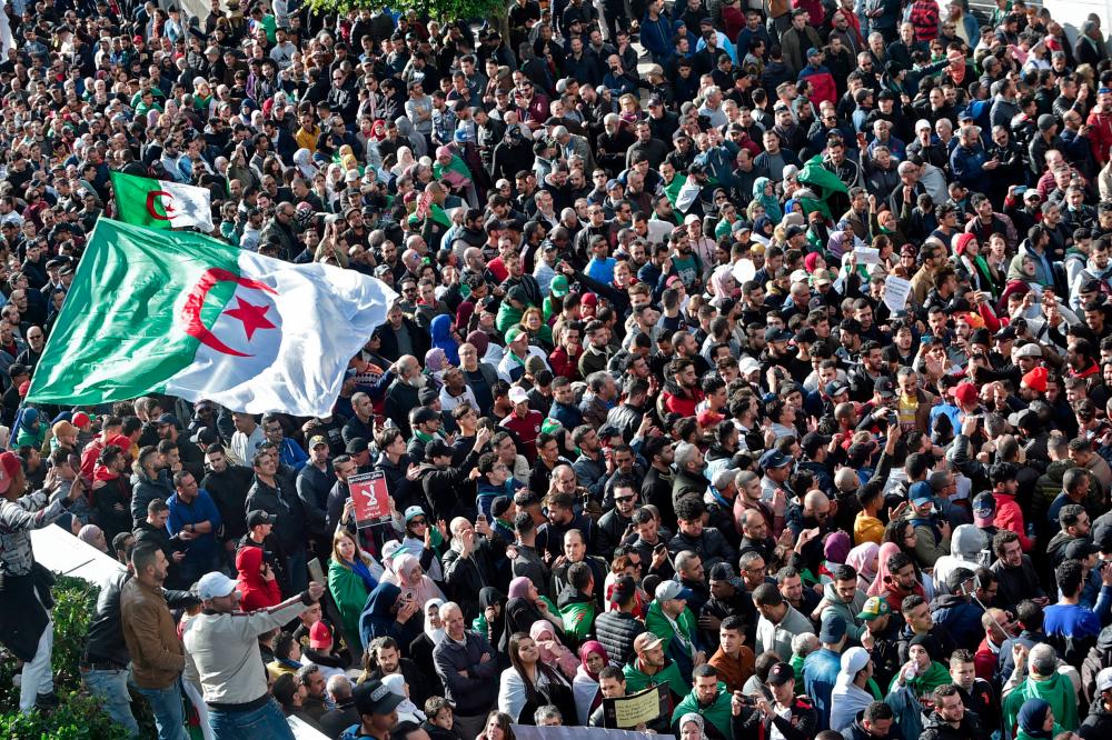 Algerian protesters take part in an anti-government demonstration in the capital Algiers on Dec 12, during the presidential election. — AFP