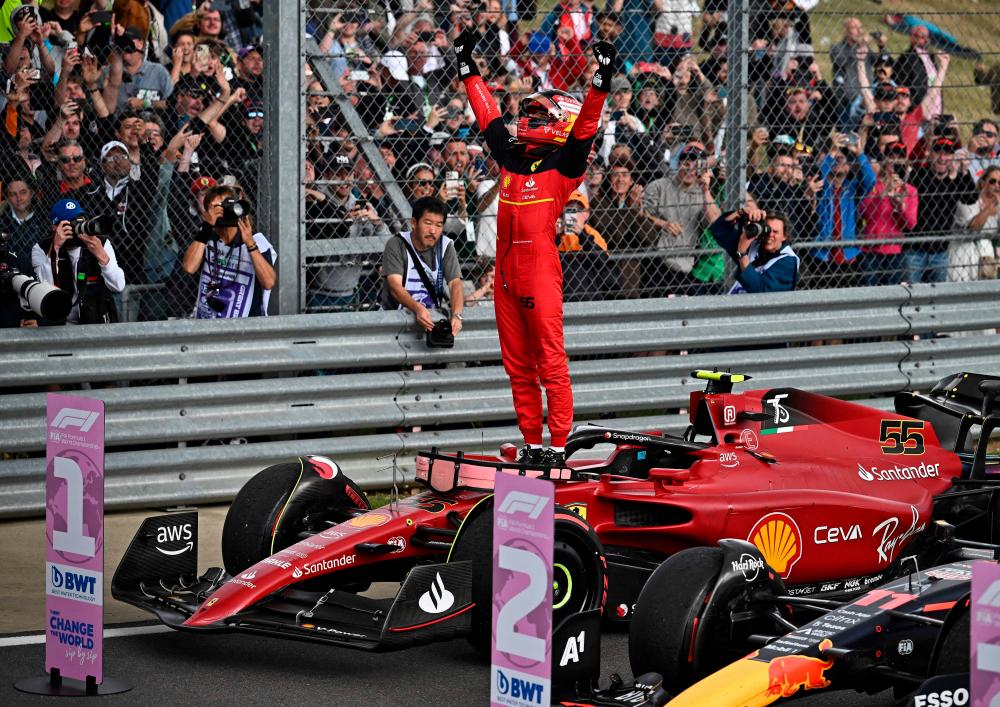 Race winner Ferrari’s Spanish driver Carlos Sainz Jr celebrates after the Formula One British Grand Prix at the Silverstone motor racing circuit in Silverstone, central England on July 3, 2022. AFPPIX