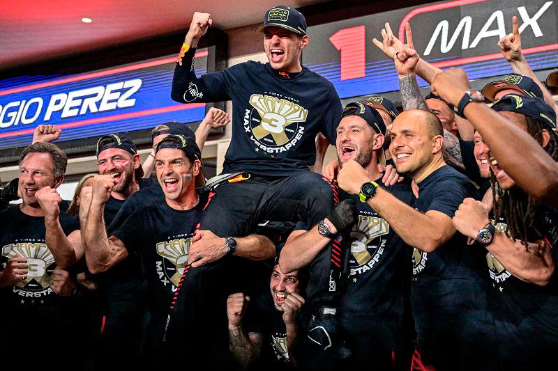 Red Bull Racing's Dutch driver Max Verstappen (C) celebrates his third world championship with his team after the sprint race ahead of the Qatari Formula One Grand Prix at the Lusail International Circuit on October 7, 2023 / AFPpix