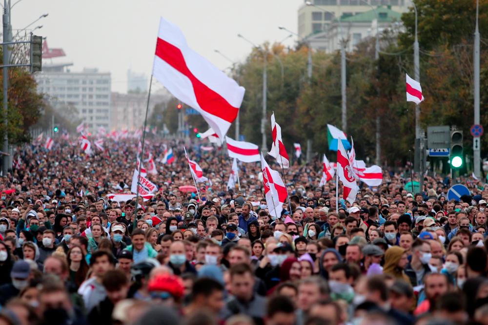 Opposition supporters parade through the streets during a rally to protest the country’s presidential inauguration in Minsk on Sept 27, 2020. — AFP