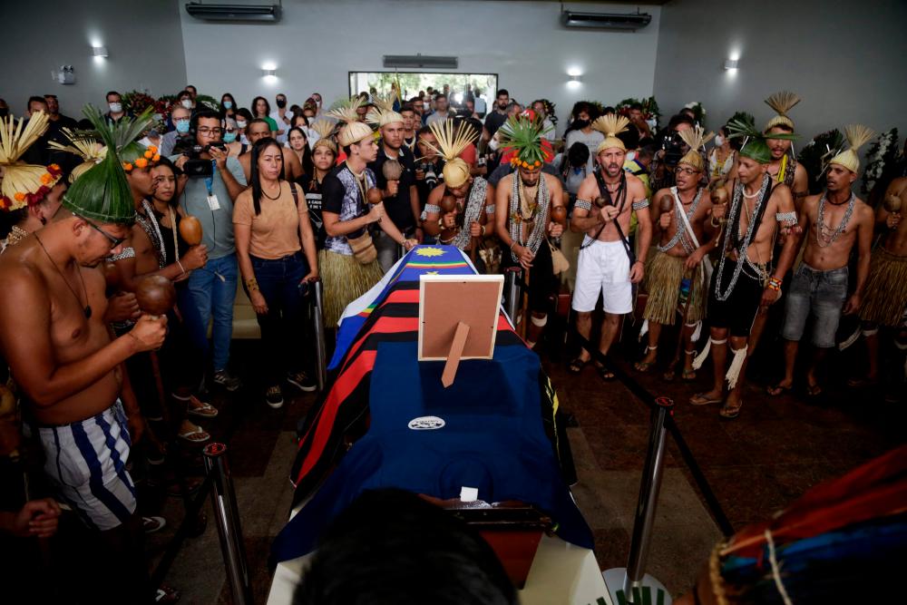 Xukuru´s indigenous people sing a sacred pray in honor of the Brazilian indigenous expert Bruno Pereira next to his coffin during his funeral at the Morada da Paz Cemetery in Paulista, Pernambuco state, Brazil, on June 24, 2022. AFPPIX