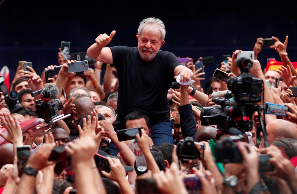 Brazilian former president (2003-2011) Luiz Inacio Lula da Silva gives his thumb up at supporters as he is taken on the shoulders through the crowd during a gathering outside the metalworkers' union building in Sao Bernardo do Campo, in metropolitan Sao Paulo, Brazil, on Nov 9. — AFP