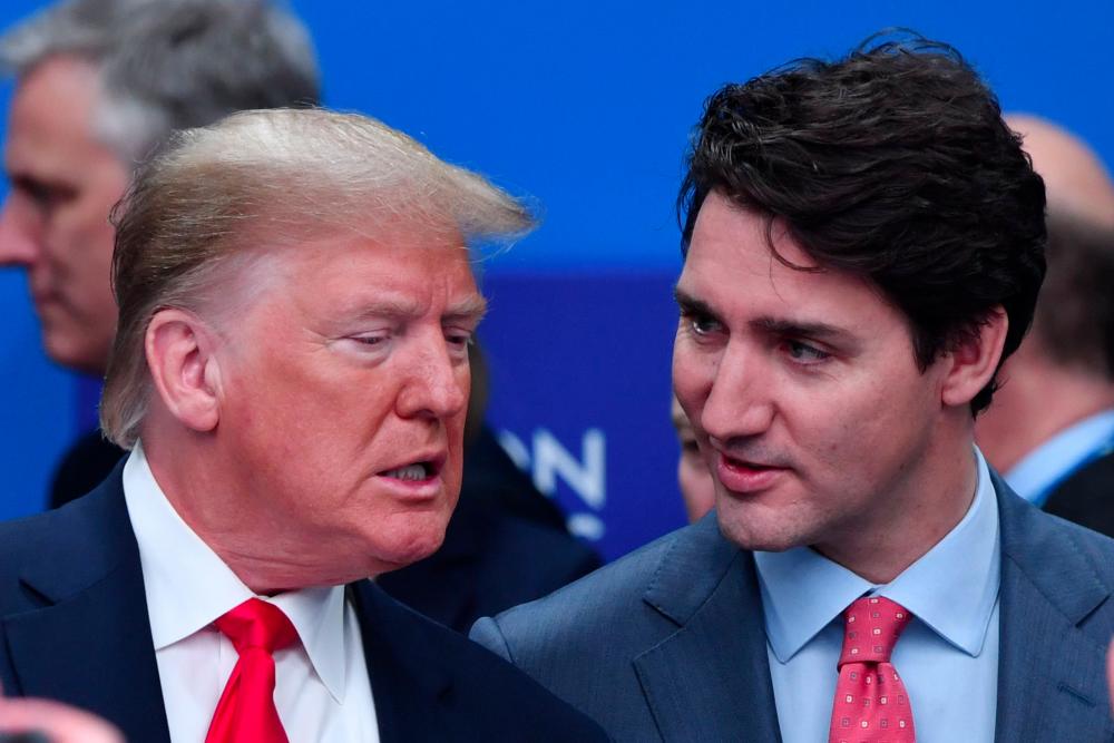 US President Donald Trump (L) talks with Canada's Prime Minister Justin Trudeau during the plenary session of the Nato summit at the Grove hotel in Watford, northeast of London on Dec 4, 2019. — AFP