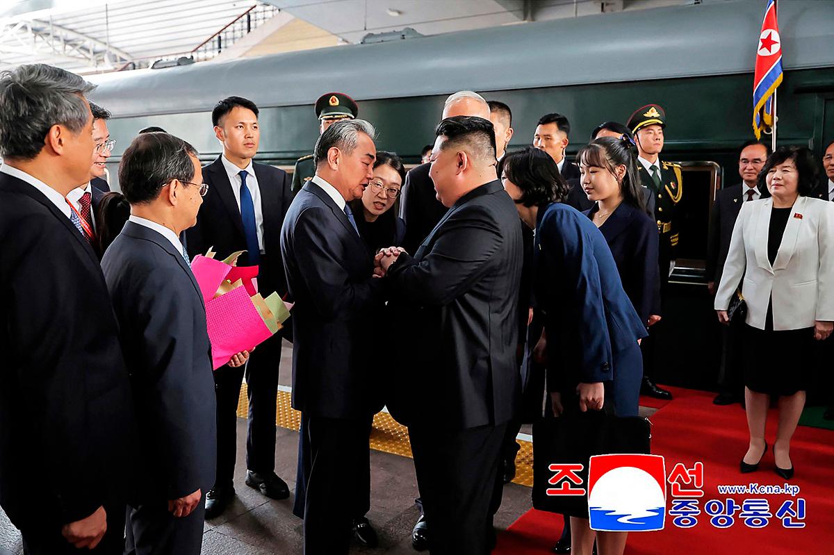 This photograph taken on September 2, 2025 and released by North Korea’s official Korean Central News Agency (KCNA) via KNS shows North Korea’s leader Kim Jong Un (centre R) and his daughter Kim Ju Ae (4th R) being greeted by China’s Foreign Minister Wang Yi (centre L) upon their arrival at the Beijing Railway Station in Beijing. - KCNA VIA KNS / AFP