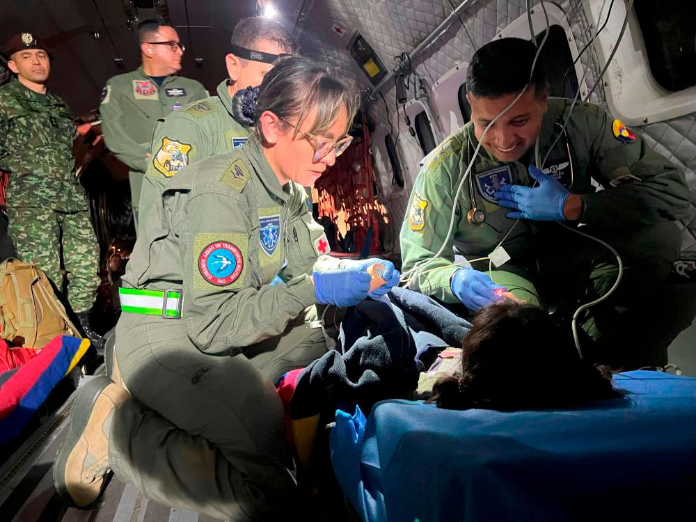 Filepix: This handout picture taken on June 9, 2023 released by the Colombian Air Force shows members of the Colombian Army checking one of the four Indigenous children who were found alive after being lost for 40 days in the Colombian Amazon rainforest following a plane crash in San Jose del Guaviare during their transfer to Bogota/AFPpix