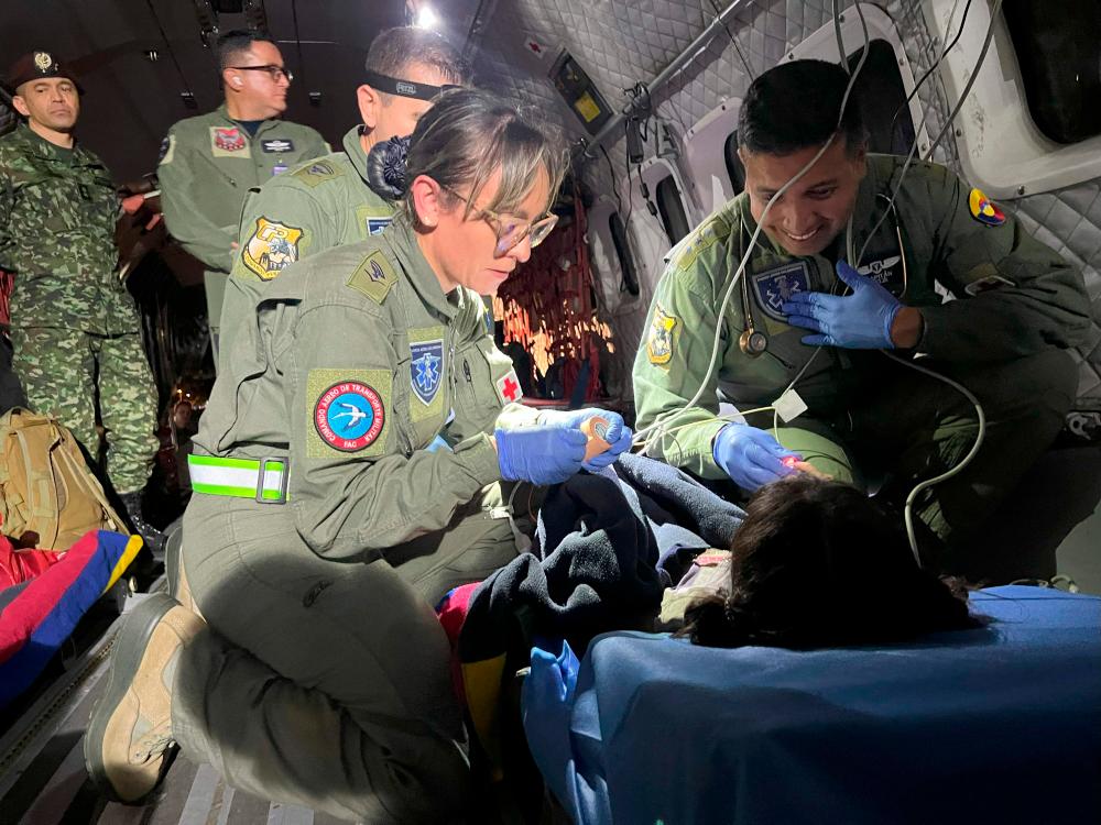 This handout picture taken on June 9, 2023 released by the Colombian Air Force shows members of the Colombian Army checking one of the four Indigenous children who were found alive after being lost for 40 days in the Colombian Amazon rainforest following a plane crash in San Jose del Guaviare during their transfer to Bogota/AFPpix
