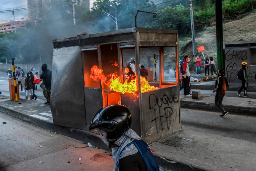Demonstrators set fire to a toll booth during a new anti-government protest in Medellin, Colombia on May 16, 2021. – AFP