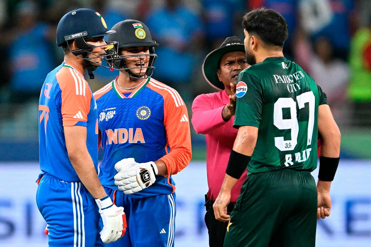 Pakistan’s Haris Rauf (R) speaks with India’s Abhishek Sharma (2L) as Shubman Gill watches during the Asia Cup 2025 Super Four Twenty20 international cricket match between India and Pakistan at the Dubai International Stadium in Dubai on September 21, 2025. -AFP