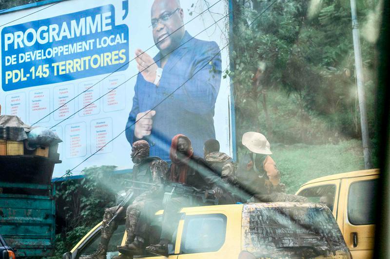 Armed Forces of the Democratic Republic of the Congo (FARDC) soldiers sit on top of a vehicle driving in the streets of Bukavu on February 14, 2025. The intensifying conflict in the eastern Democratic Republic of Congo (DRC) has provoked fears of a regional war. Several of the DRC's nine neighbouring countries, as well as South Africa, already have a military presence on the ground. For the last 30 years, successive conflicts in eastern DRC have turned the heart of the African Great Lakes region into a tinderbox ready to catch fire. - Amani Alimasi / AFP