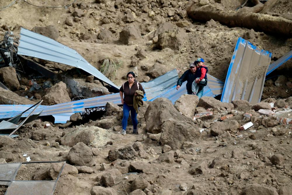 Residents abandon their homes after a landslide in Alausi, Ecuador on March 28, 2023. AFPPIX