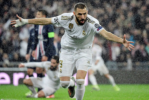 Real Madrid’s French forward Karim Benzema celebrates his goal during the UEFA Champions League group A football match against Paris Saint-Germain FC at the Santiago Bernabeu stadium in Madrid on Nov 26 — AFP