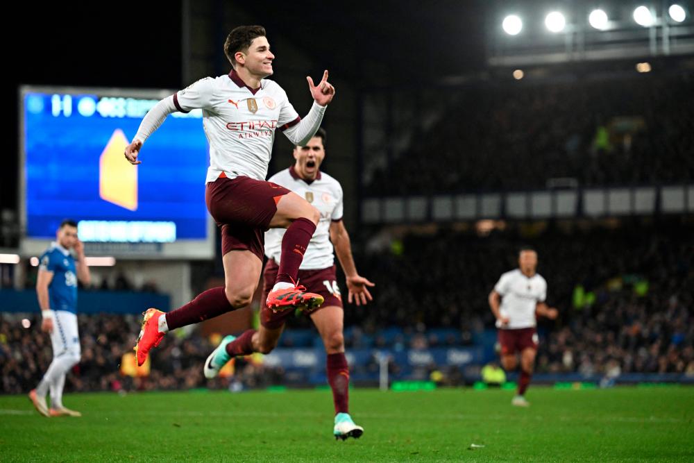 TOPSHOT - Manchester City's Argentinian striker #19 Julian Alvarez (L) celebrates after scoring his team second goal during the English Premier League football match between Everton and Manchester City at Goodison Park in Liverpool, north west England on December 27, 2023. - AFPPIX