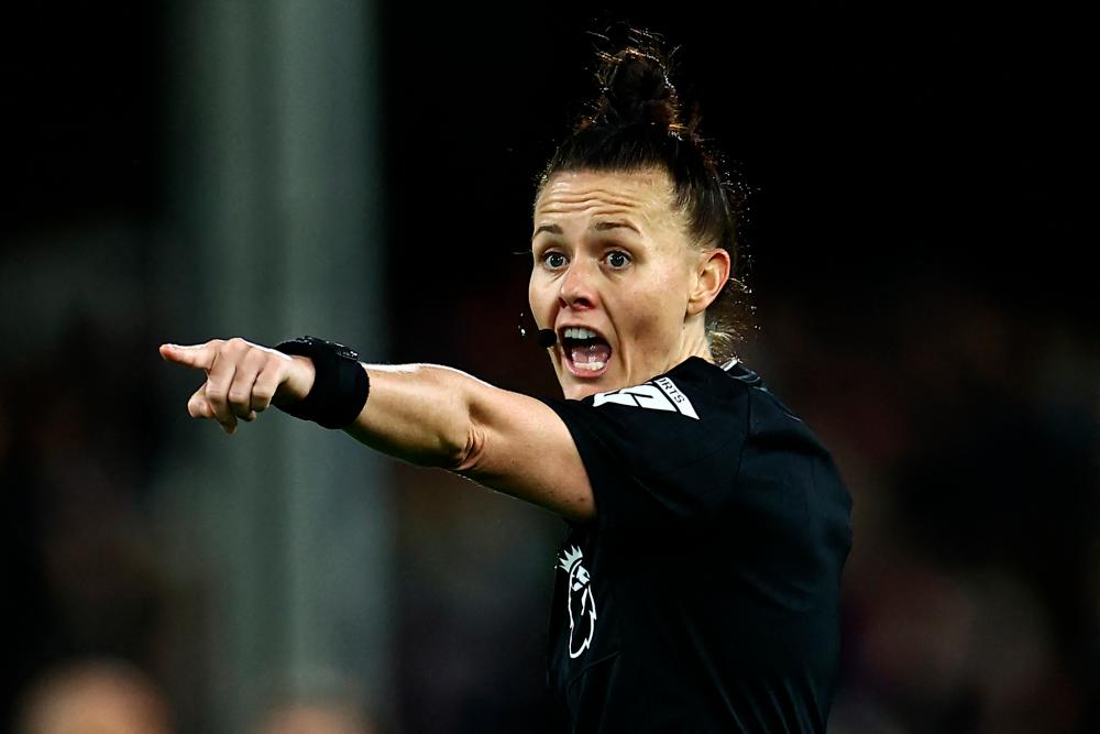 TOPSHOT - English referee Rebecca Welch gestures during the English Premier League football match between Fulham and Burnley at Craven Cottage in London on December 23, 2023. - AFPPIX