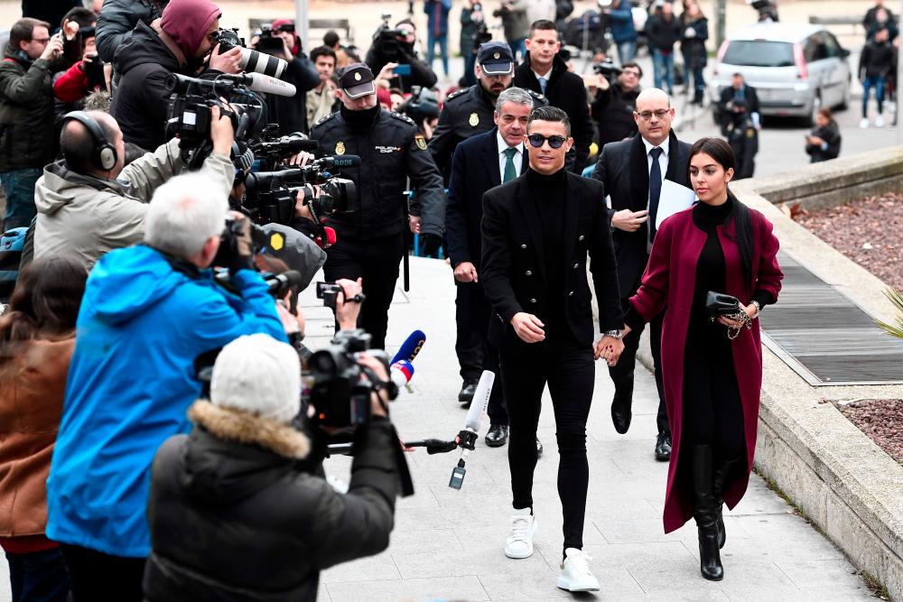 Juventus' forward and former Real Madrid player Cristiano Ronaldo arrives with his Spanish girlfriend Georgina Rodriguez to attend a court hearing for tax evasion in Madrid on Jan 22, 2019. — AFP