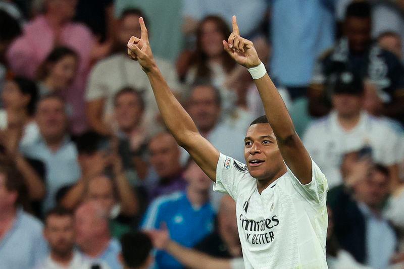 Real Madrid's French forward #09 Kylian Mbappe celebrates after scoring his team's first goal during the UEFA Champions League 1st round day 1 football match between Real Madrid CF and Stuttgart VFB at the Santiago Bernabeu stadium in Madrid on September 17, 2024. - AFPPIX