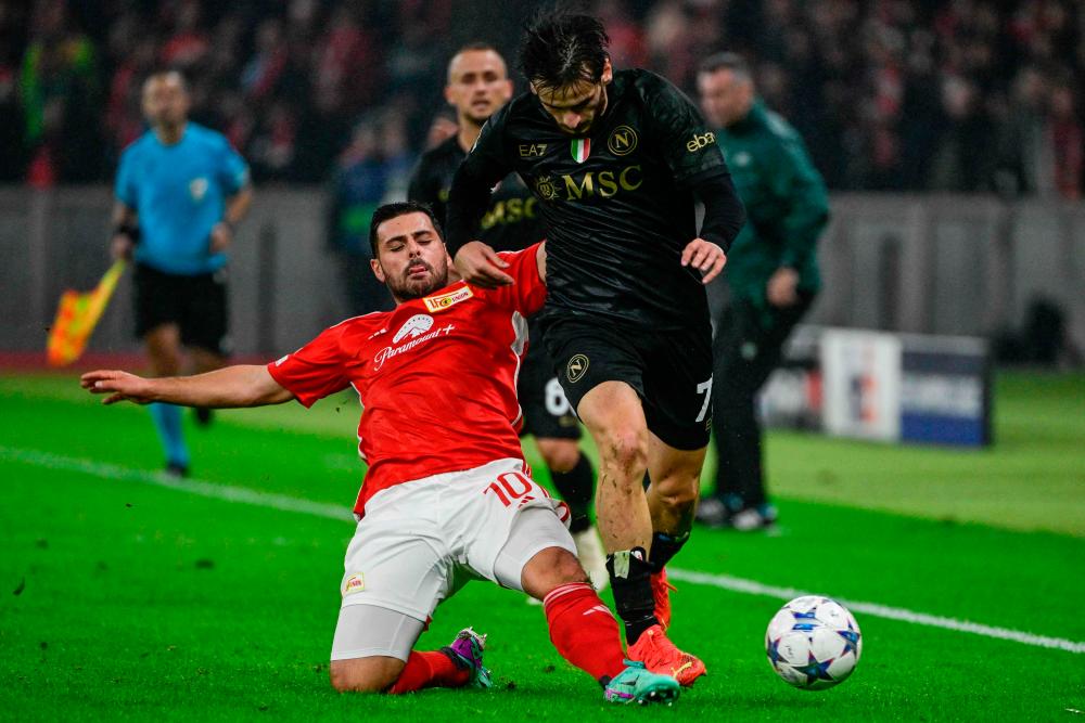 Khvicha Kvaratskhelia (R) is tackled by Union Berlin’s German forward #10 Kevin Volland during the UEFA Champions League group C football match 1 FC Union Berlin v SSC Napoli at the Olympic Stadium in Berlin on October 24, 2023. AFPPIX
