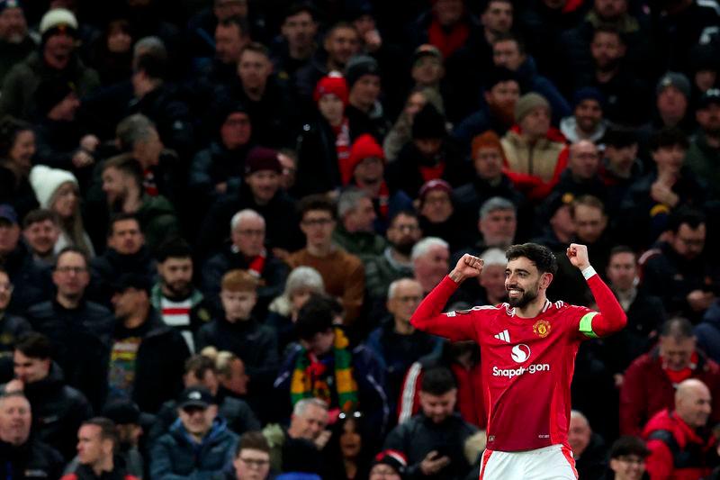 Manchester United's Portuguese midfielder #08 Bruno Fernandes celebrates scoring the team's second goal from the penalty spot during the UEFA Europa League Last 16 Second Leg football match between Manchester United and Real Sociedad at Old Trafford stadium in Manchester, north west England, on March 13, 2025.- AFPPIX